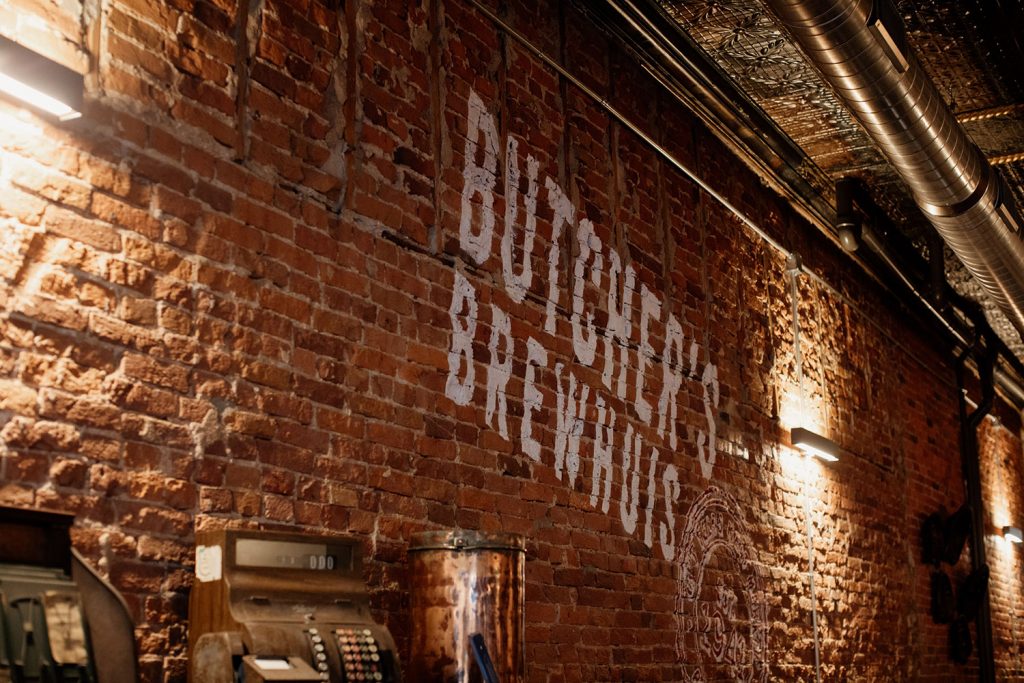 Butcher's Brewhuis logo on brick wall